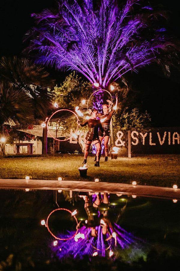 Fire performer during a choreographed fire show at an Ibiza event